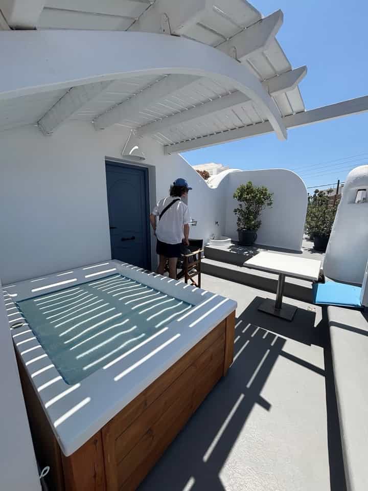 The hot tub, patio, and entrance to our suite in Firostefani.