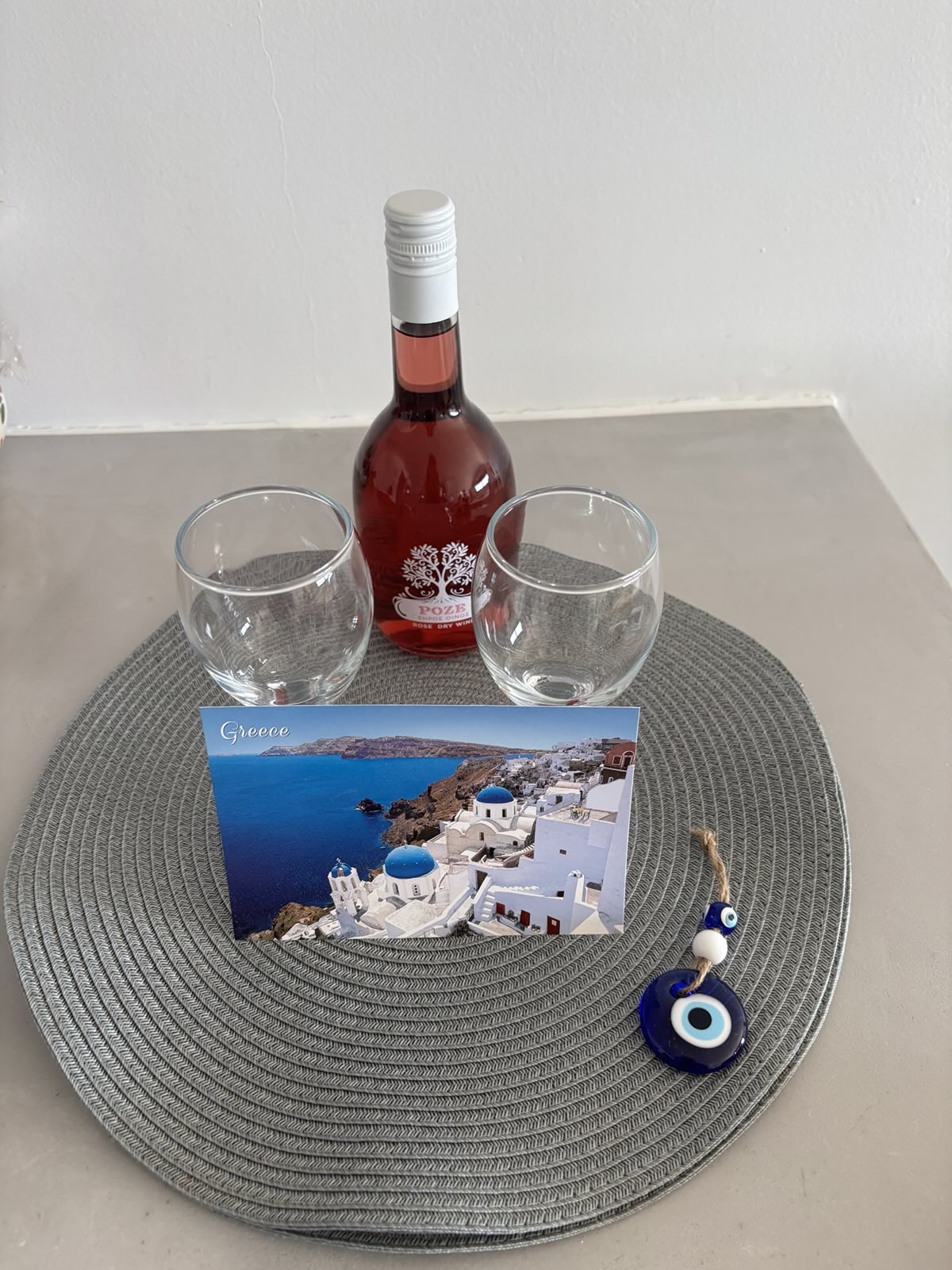 Our host had left a bottle of dry rose wine, a nice card, and an evil-eye charm to greet us.
