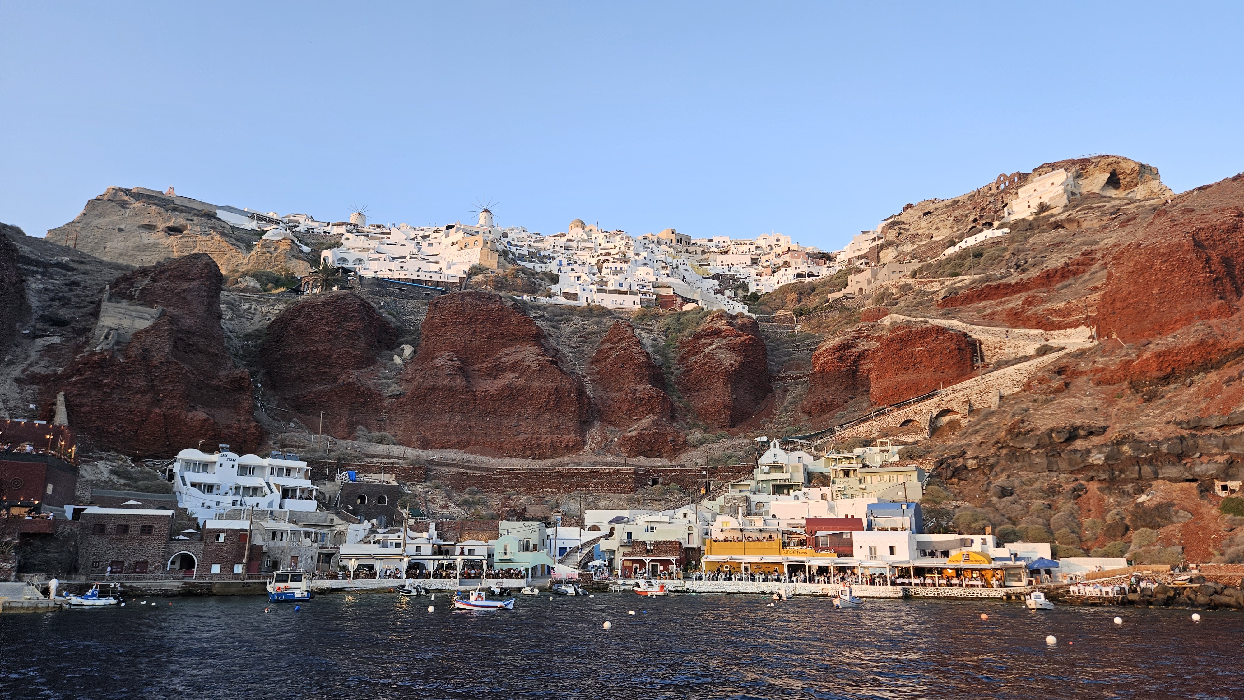 The city of Oia, and port below.